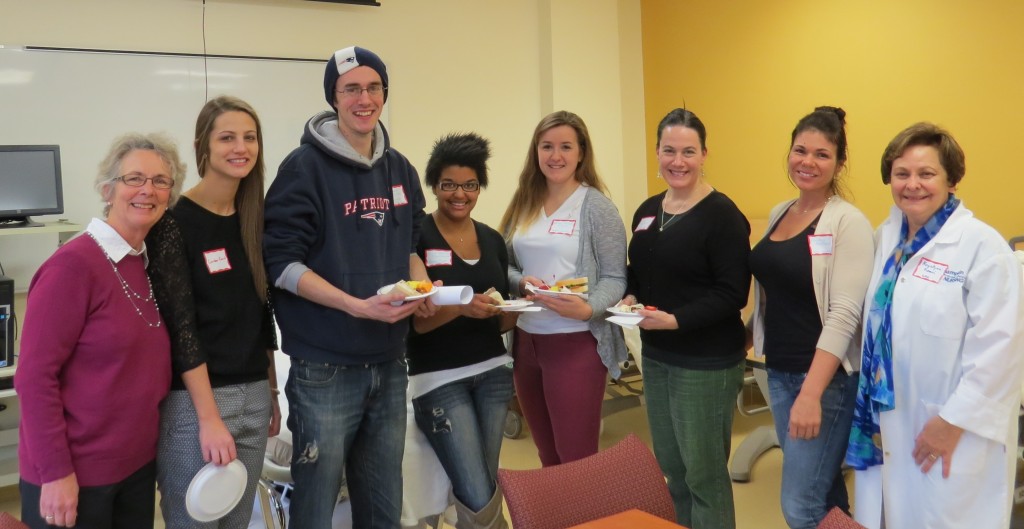 Carol Mooney (left) and Krystyna Kouri (left) with students and teachers in the nursing program